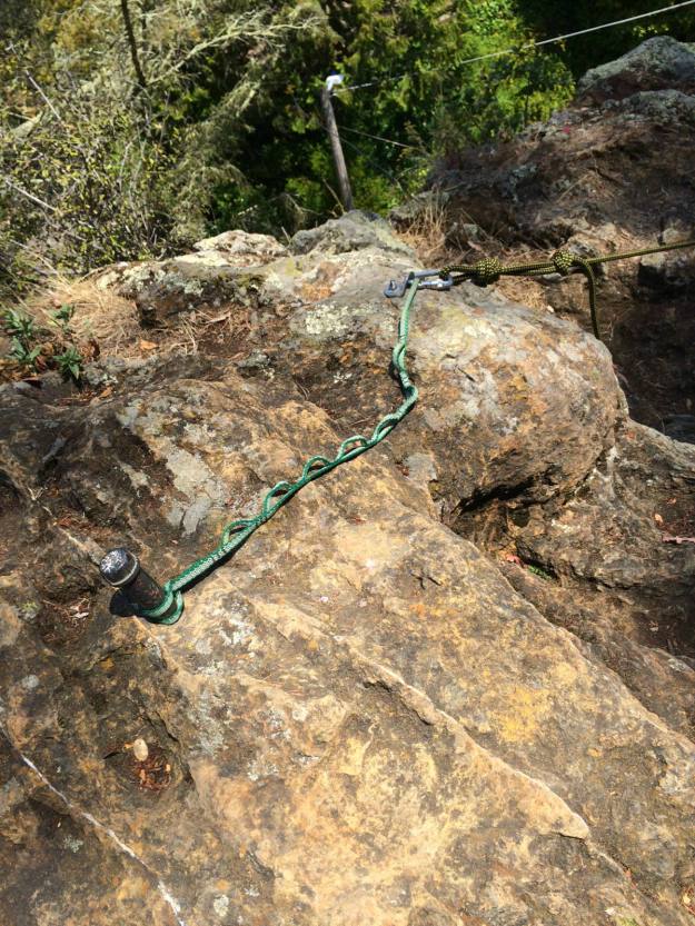 Someone actually backed up an anchor bolt with a daisy chain girth hitched around a bit of pipe in the rock. 